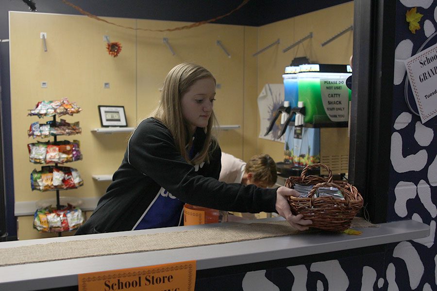 Setting out gum, senior Ally Appl prepares for the opening of the Catty Shack. Opening day was pretty good and kept me on my toes, for sure, Appl said. I decided to help run the Catty Shack because I saw all that it did and I wanted to make it better than before.