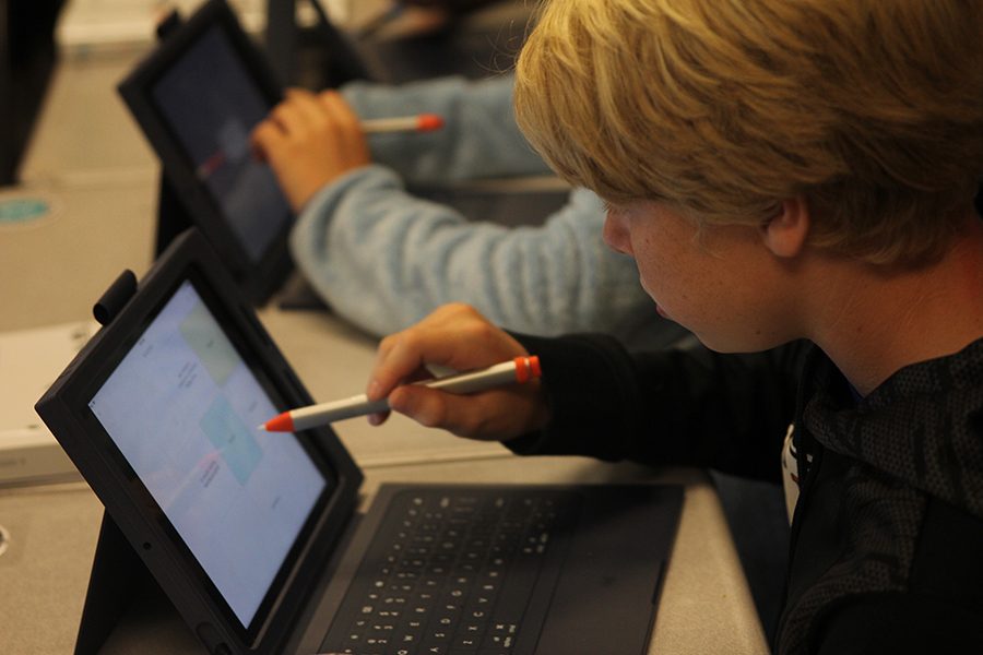 A freshman plays a game on an iPad to help him study on Thursday, Oct. 4 in Honors English I.