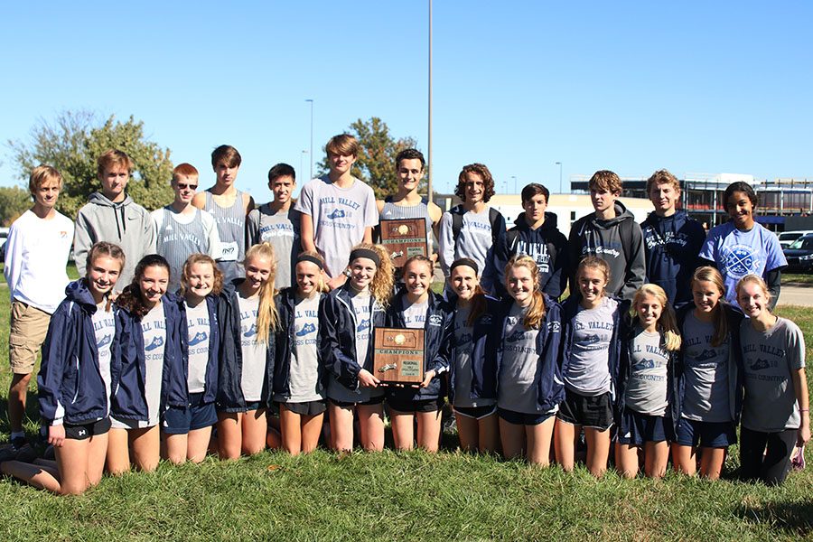 After winning the 6A regional meet, the boys and girls cross country team take a picture together with the plaques. 