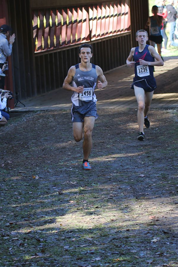 Passing over the bridge, senior Matthew Turner lengthens his strides. Turner placed 13th individually. 