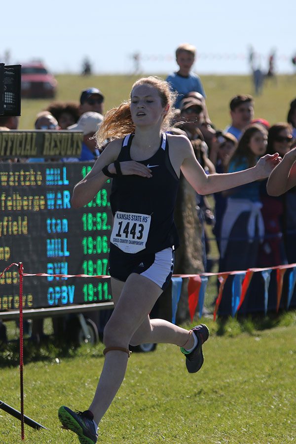 Giving maximum effort, sophomore Molly Ricker runs through the finish line. Ricker placed 10th individually.