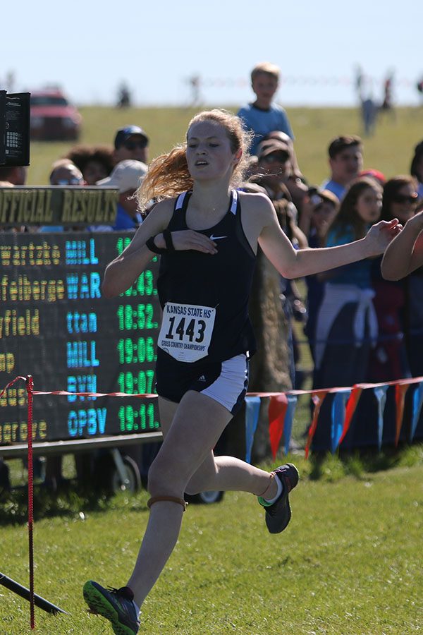 Giving maximum effort, sophomore Molly Ricker runs through the finish line. Ricker placed 10th individually.