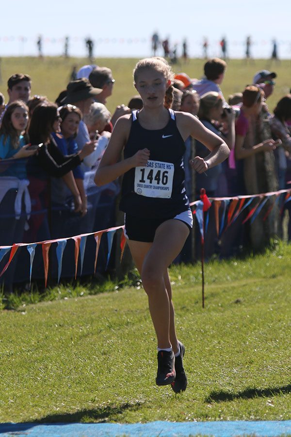 Medaling at state for the second year, sophomore Josie Taylor crosses the finish in 19th.