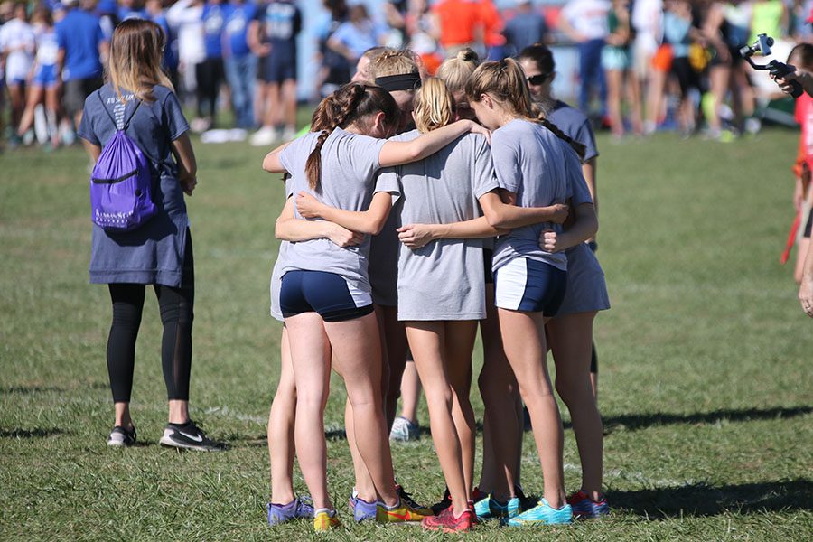 With only minutes until race time, the girls team huddles up to share last words of encouragement.