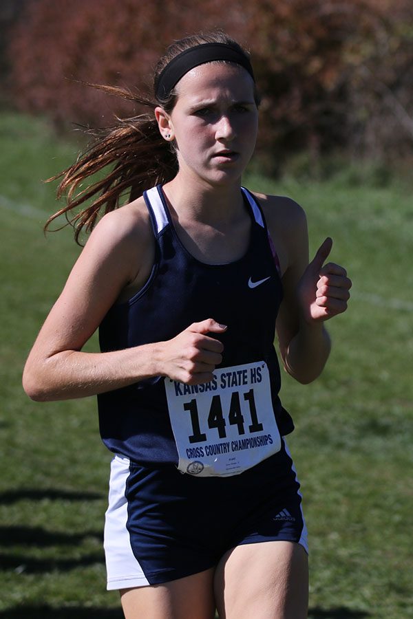 Focused straight ahead, junior Morgan Koca passes the first mile marker.
