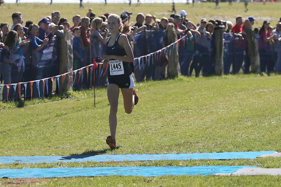 Crossing the finish line with a time of 19:18, freshman Katie Schwartzkopf becomes the 6A state champion.
