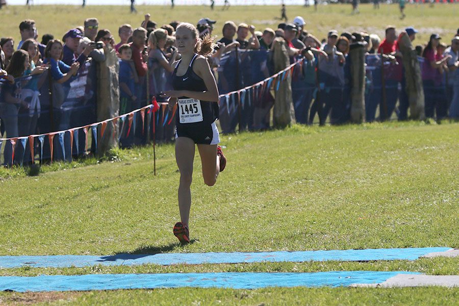 Crossing the finish line with a time of 19:18, freshman Katie Schwartzkopf becomes the 6A state champion.
