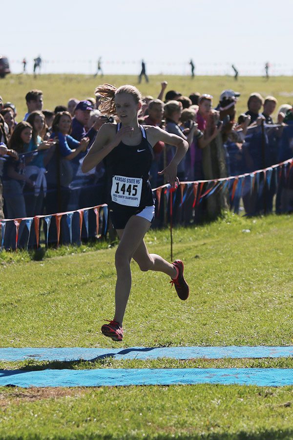 Crossing the finish line with a time of 18:19, freshman Katie Schwartzkopf becomes the 6A state champion.
