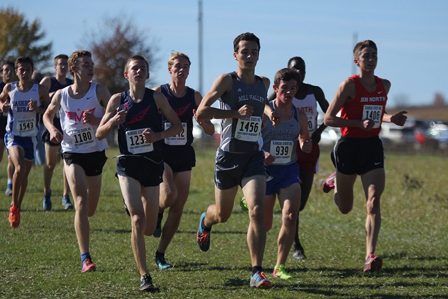 Running along the first straight away of the race, senior Matt Turner keeps pace with the other runners to get ahead later in the race.