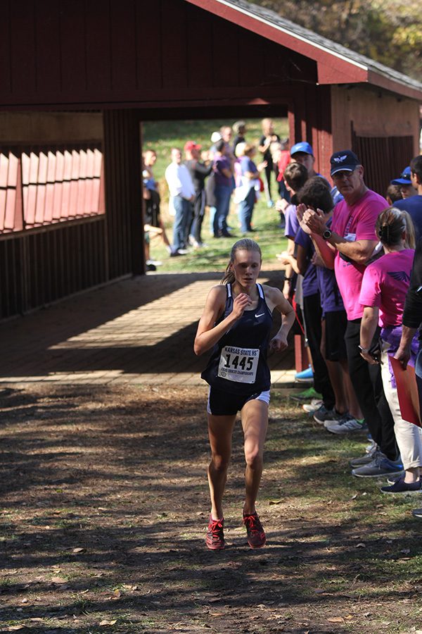 Before placing 1st, freshman Katie Schwartzkopf crosses under Kings Bridge on the Rim Rock Farm cross country course on Oct. 27th.