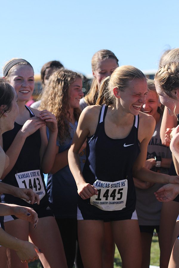 Celebrating with fellow teammates, freshman Katie Schwartzkopf smiles after hearing the news of their first place state placing.