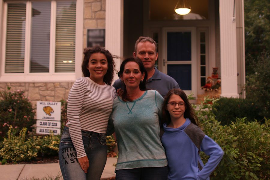 With her host family, the Hansons, senior foreign exchange student Gabriella Silva Moura stands in front of their house on Tuesday, Sept. 25. “It was always my dream to go to another country to know another culture and language,” said Silva Moura. “So I chose the United States.”