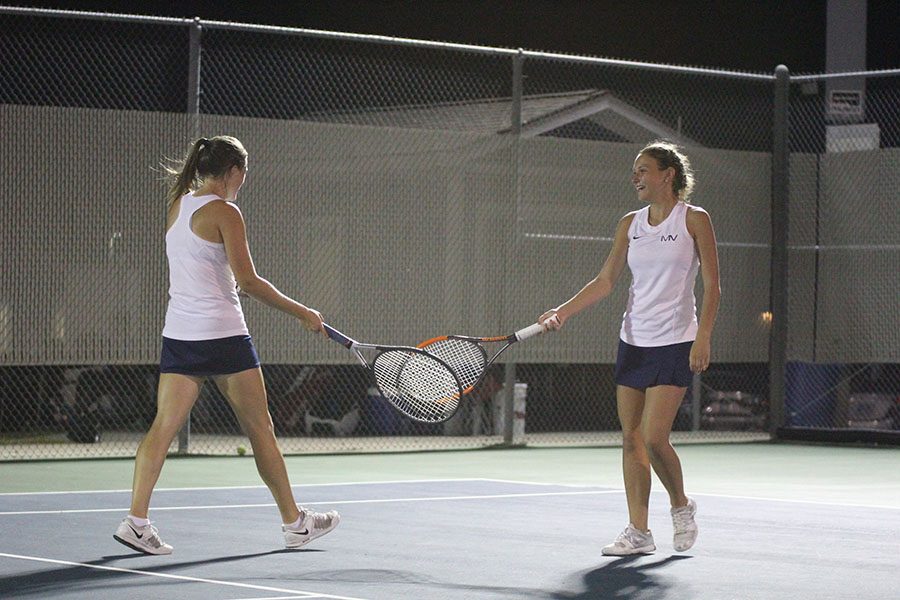 After winning their first set, senior Anika Roy and junior Avery Altman clink rackets in celebration. With this win, the duo went on to place 4th overall, and secure a spot for the  state tournament. I think it was tough keeping my self calmed down, but Anika and I played really well together, Altman said. I couldnt of asked it to go any better.