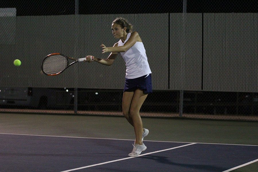 Junior Avery Altman forehands the ball down the line.