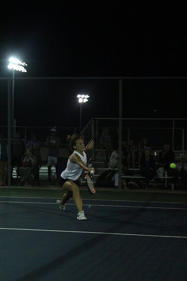 Reaching out for the ball, junior Avery Altman attempts to hit the ball back over the net for the point.