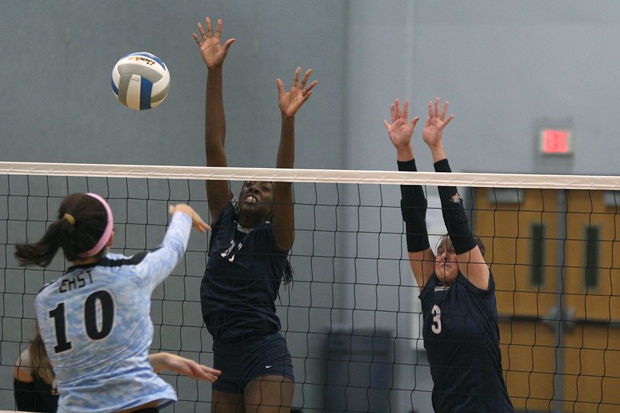 As their opponent hits the ball, junior Faith Archibong and sophomore Jaden Ravensborg block it. The team competed in the sub-state tournament on Saturday, Oct. 20, and lost to Olathe Northwest in the final round of pool play. They placed eighth overall.