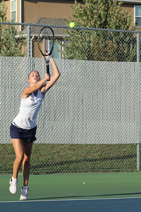 Senior Jordan Dean serves the ball.