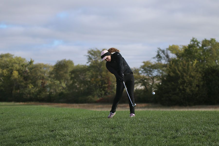 On Thursday, Oct. 11, junior Hannah Davie chips the ball onto the green at the 6A Gardner Edgerton regional tournament. The team did great. We were playing in bad weather conditions in the morning and that had an effect on our scores, said Davie. Before state, we need to keep staying consistent throughout the rounds and finish strong on the last holes.