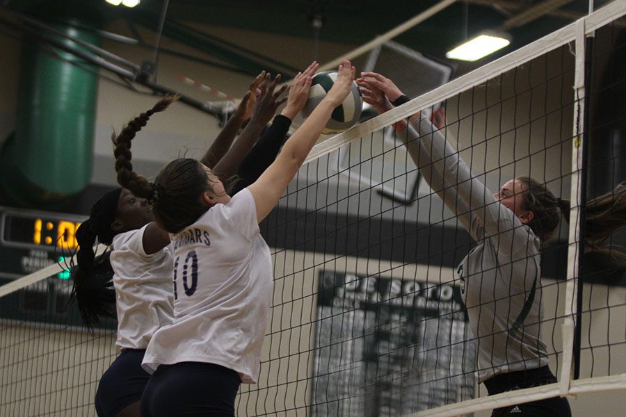 With the ball at the net, junior Faith Archibong and sophomore Molly Carr fight their opponent for possession. [The team] did well at doing what we needed to do, Carr said. The volleyball team competed in the Spikefest tournament on Saturday, Oct. 6, and placed fourth. 