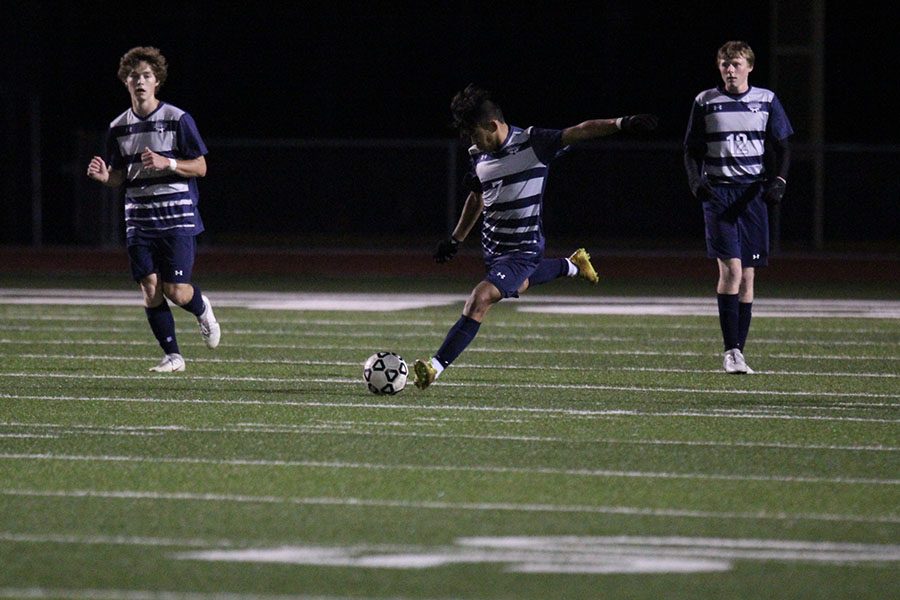 With full control of the ball, junior Wesley Sirivongxay kicks the ball towards the goal.