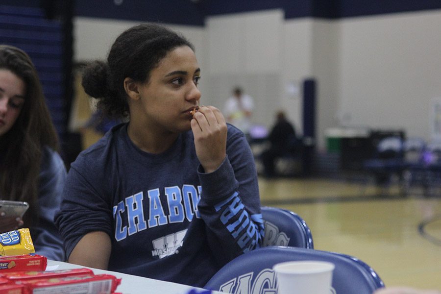 Senior Sydney Pullen watches the blood drive while snacking on some pretzels.