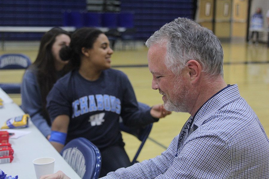 After having his blood drawn, science teacher Chad Brown enjoys the complementary snacks.