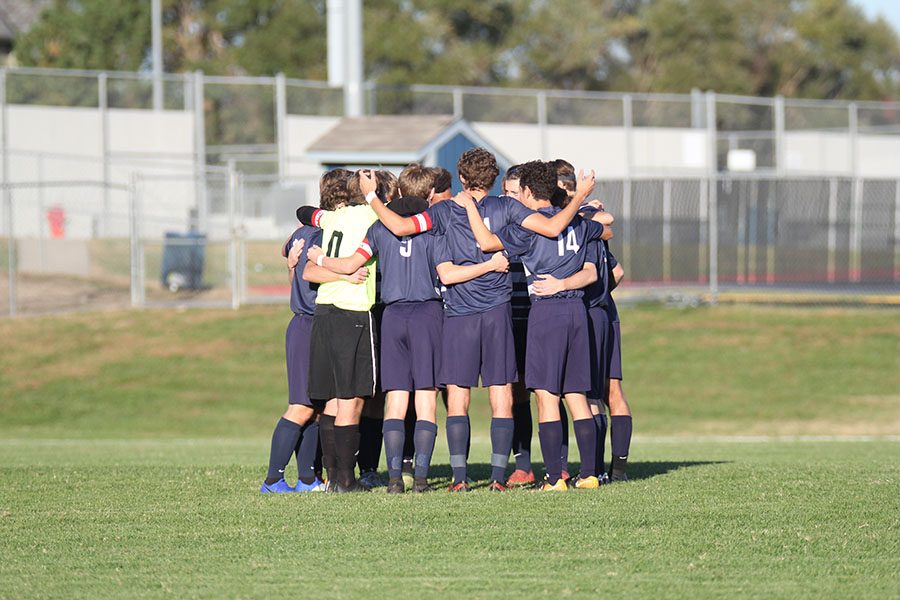 Before the game, the boys soccer team huddles up for a pep talk. “It’s the post season, so [losing] is always at the back of our minds and they scored two,” senior team captain Jake Ashford said. “Especially at the second part of the second half, it was close.” 
