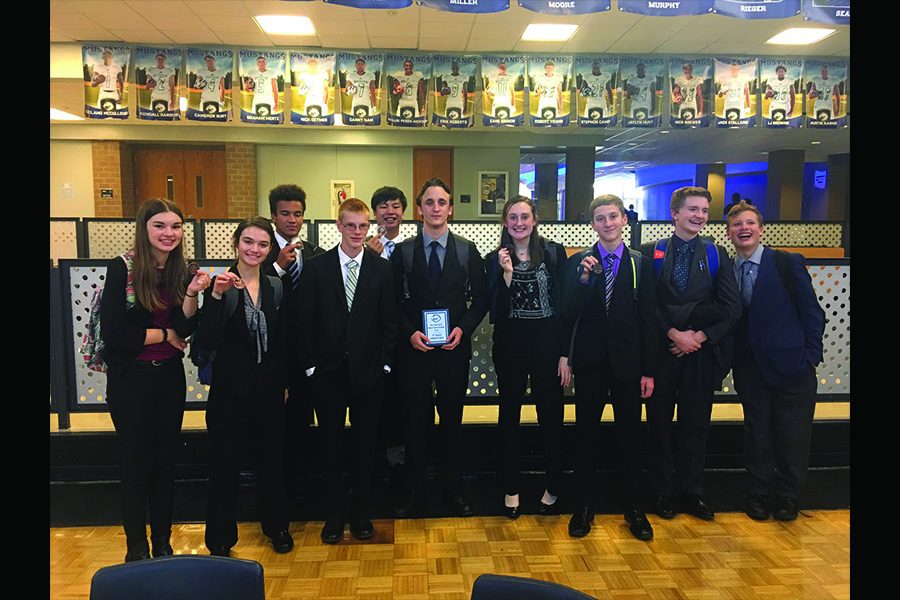 After learning the results of the two-day long tournament, the debate team proudly shows off their awards on Saturday, Oct. 13.
