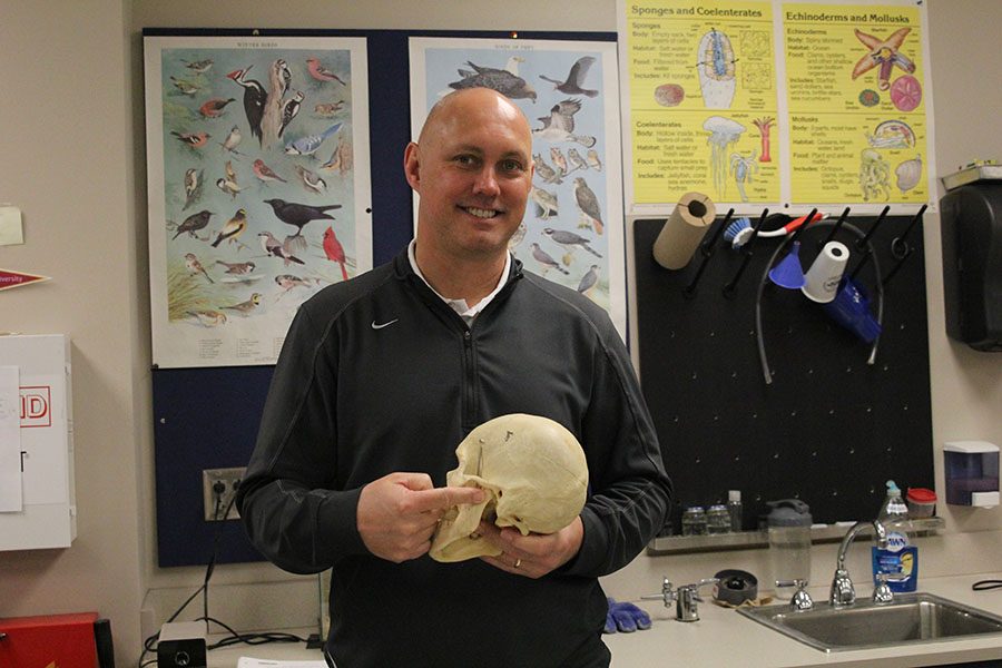Hold a human skull, science teacher Eric Thomas points to the ear opening on Tuesday, Dec. 4.