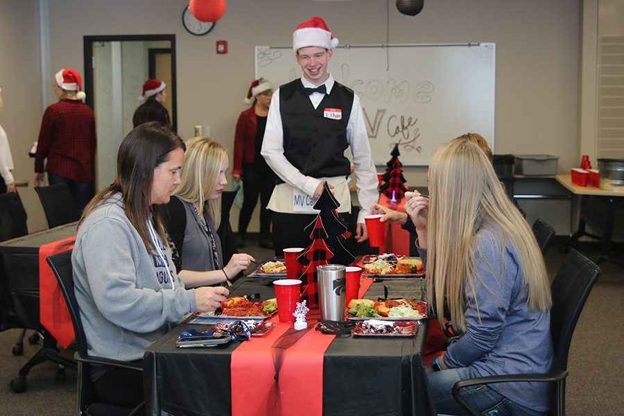 Practicing his skills as a server at the annual “MV Cafe” event on Friday, Nov. 30, junior Ethan Males greets teachers and asks their opinion on the meal prepared by students.
