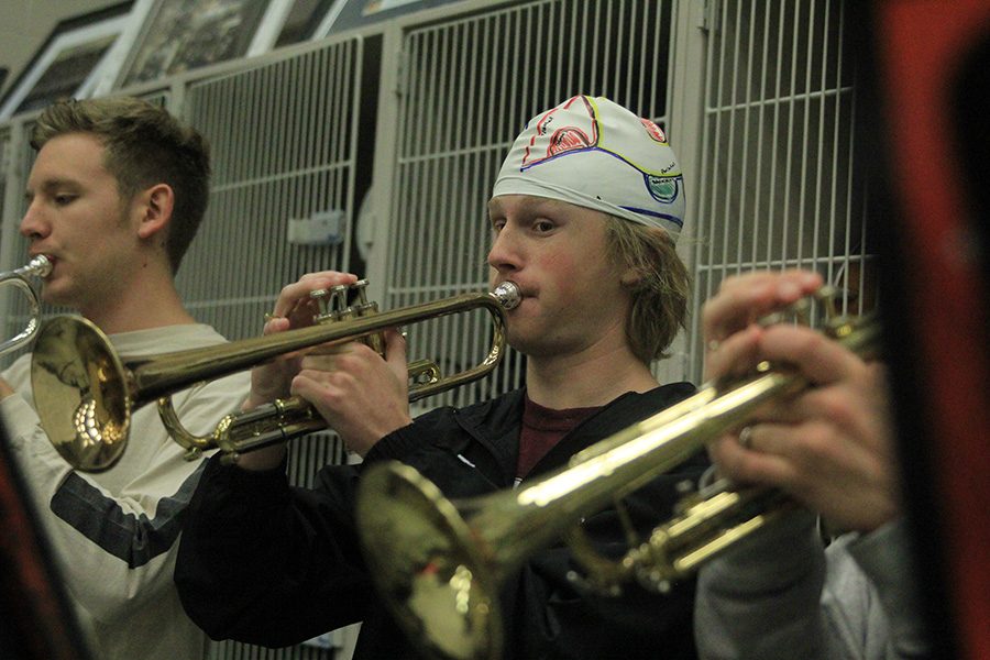 For extra credit in his AP Psychology class, junior Andrew Tow wears his “brain cap” while playing his trumpet, showing the parts of the brain he uses while making music.
