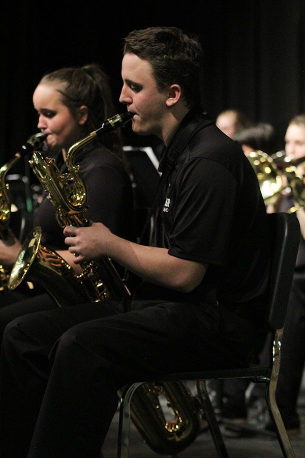 Holding his note to compliment the sound of the alto saxophones, junior Travis Babcock performs with his baritone saxophone at the Jazz Band concert in the Little Theatre on Thursday, Nov. 29th.