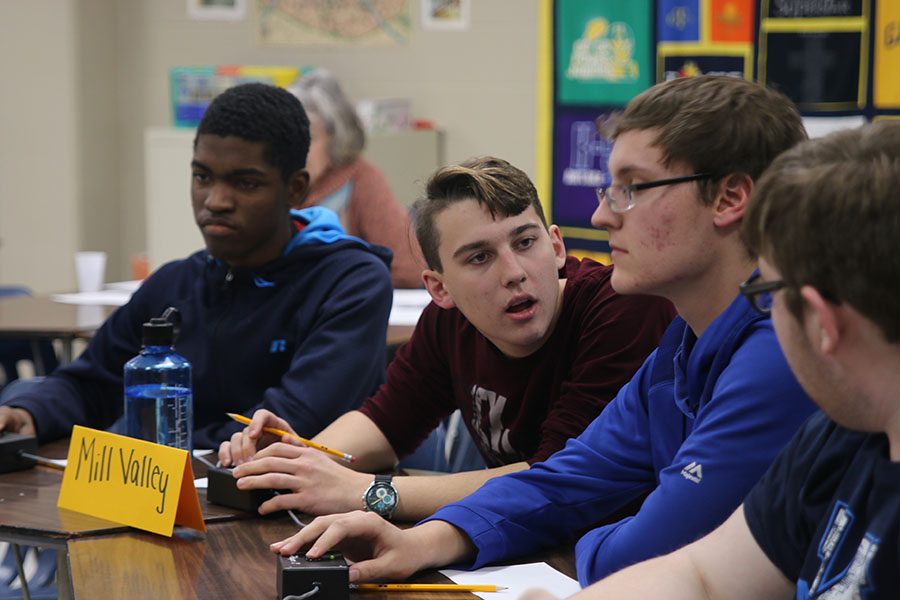 Getting ready to press the buzzer, senior Johannes Seberger discusses to the team about an answer at the Saint Thomas Aquinas tournament on Thursday, Nov. 15. I think we had a pretty good performance for today, Seberger said. We did have a tournament earlier in the week, so I think some of us were just tired and busy with classes [which] factored into us not having the best performance that we could have. The team finished with a 4-3 record at the tournament.