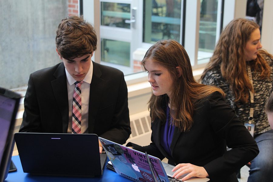 Working on their computers, sophomores Dutch Platt and Parker Trollinger prepare for the upcoming round. The resolution for this year discusses whether immigration should be more or less restricted by the federal government.