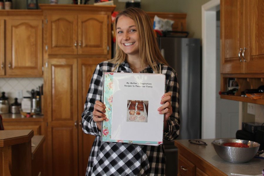 After making her homemade pumpkin spice latte Friday, Nov. 2, senior Adelle Warford shows off her family’s recipe book. Every year at 
Thanksgiving, Warford cooks the meal with her family. 