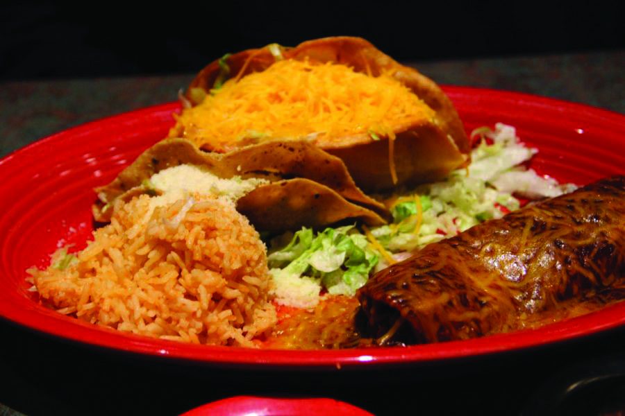 The dish ‘La Reyna’ consists of a beef taco and a chicken taco, along with a chicken enchilada, which is covered in sauce and cheese. The sides were fried rice and beans.