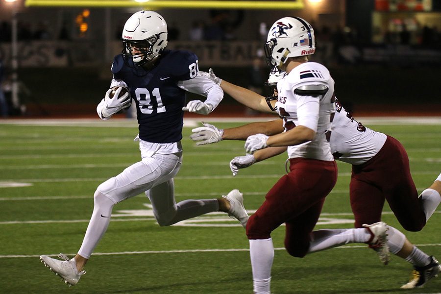 Running toward the sideline, senior wide receiver Grant Rachwal nearly misses SJA defenders.