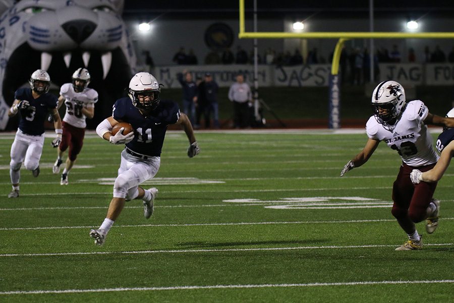 After intercepting the ball, senior defensive back Ben Hansen carries the ball down the field.