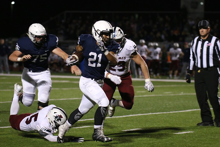 Dodging a tackle, junior running back Tyler Green continues to advance the ball.