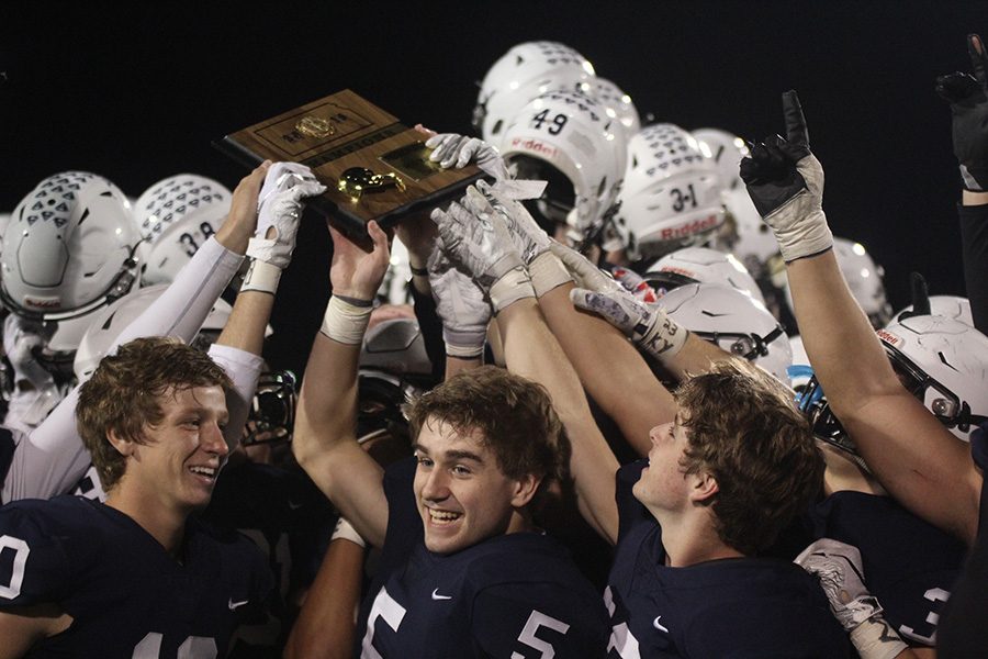 Smiling alongside teammates, senior wide receiver Logan Talley celebrates the team winning the regional title. The Jaguars defeated St. James 24-7 on Friday, Nov. 2. 