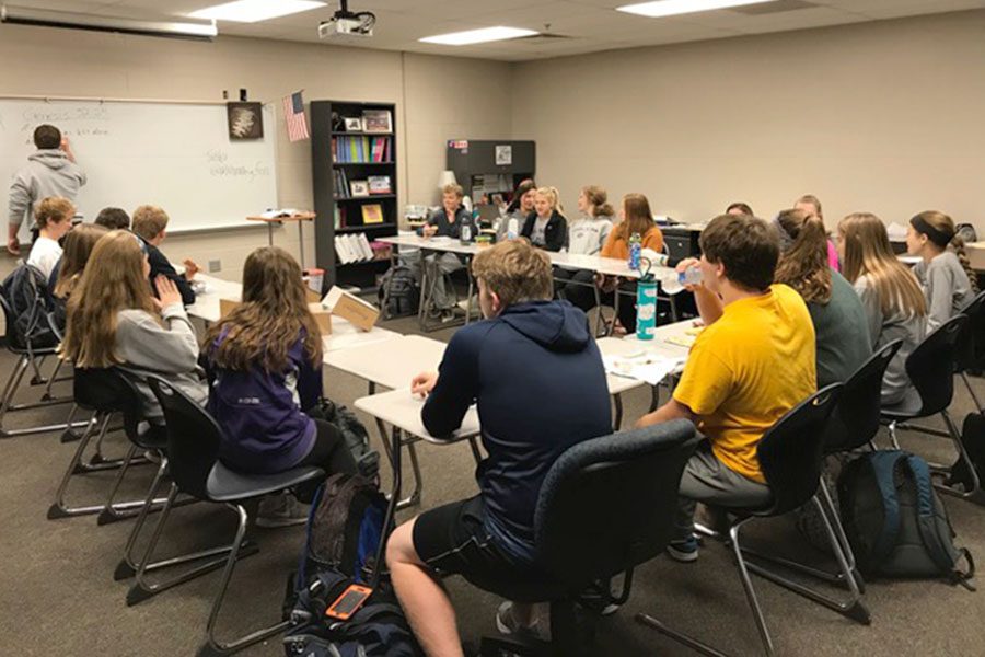 Members of Fellowship of Christian Athletes sit in a collection of desks as they wait for the morning meeting to begin. “The purpose of FCA is to unite athletes who are also christians. Sports tie into Christ so we can relate to each other about the same things,” junior Morgan Koca said.