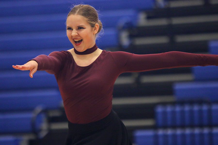 Preparing to go into a turn, junior Sydney Ebner points her arms out during her solo, which placed tenth among juniors at the Kansas City Classic on Saturday, Dec. 8.
