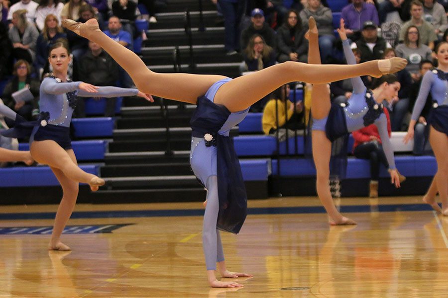 During the lyrical jazz routine at the Kansas City Classic on Saturday, Dec. 8, senior Addie Ward does a front walkover.
