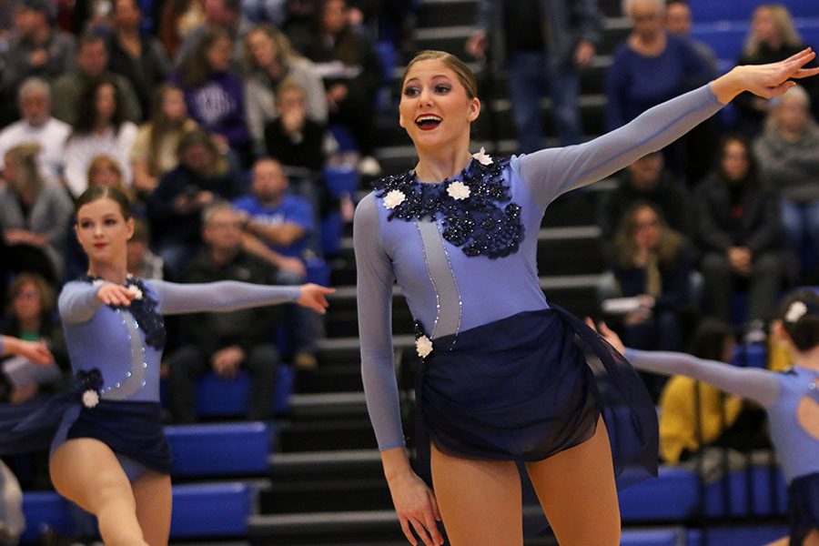 Pointing her arm out, senior Addie Ward performs in the lyrical jazz routine at the Kansas City Classic on Saturday, Dec. 8.