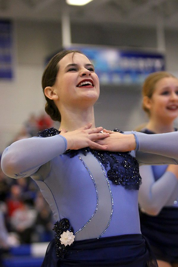 Holding her hands to her chest, senior Olivia Augustine expresses emotion during the lyrical jazz routine. This routine placed first in Division 3 at the Kansas City Classic on Saturday, Dec. 8.
