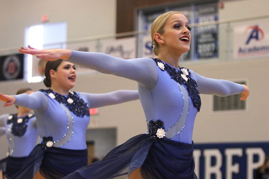 Reaching her arms out before a seconde turn, senior Bella Line smiles while performing the lyrical jazz routine at the Kansas City Classic on Saturday, Dec. 8.