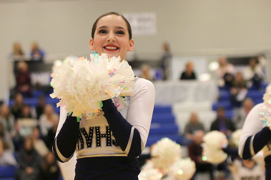 Holding her poms together during the pom routine, sophomore Tyler Bret performs at the Kansas City Classic on Saturday, Dec. 8.