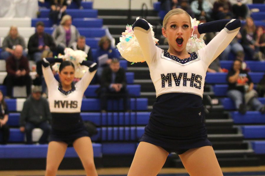 Holding her poms behind her head, senior Bella Line shows emotion in the pom routine. This routine placed first in Division 3 at the Kansas City Classic on Saturday, Dec. 8.
