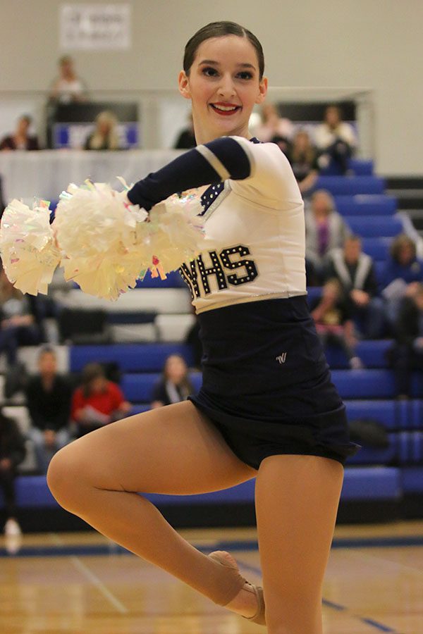 Doing a pirouette, sophomore Tyler Bret performs in the pom routine at the Kansas City Classic on Saturday, Dec. 8.