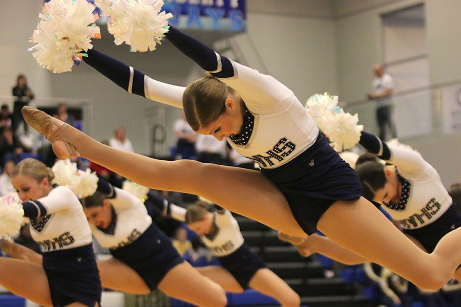 In a hurdler, senior Addie Ward performs in the pom routine. This routine placed first in Division 3 at the Kansas City Classic on Saturday, Dec. 8.
